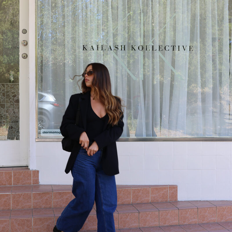 Chelsea walking past Kailash Kollective storefront